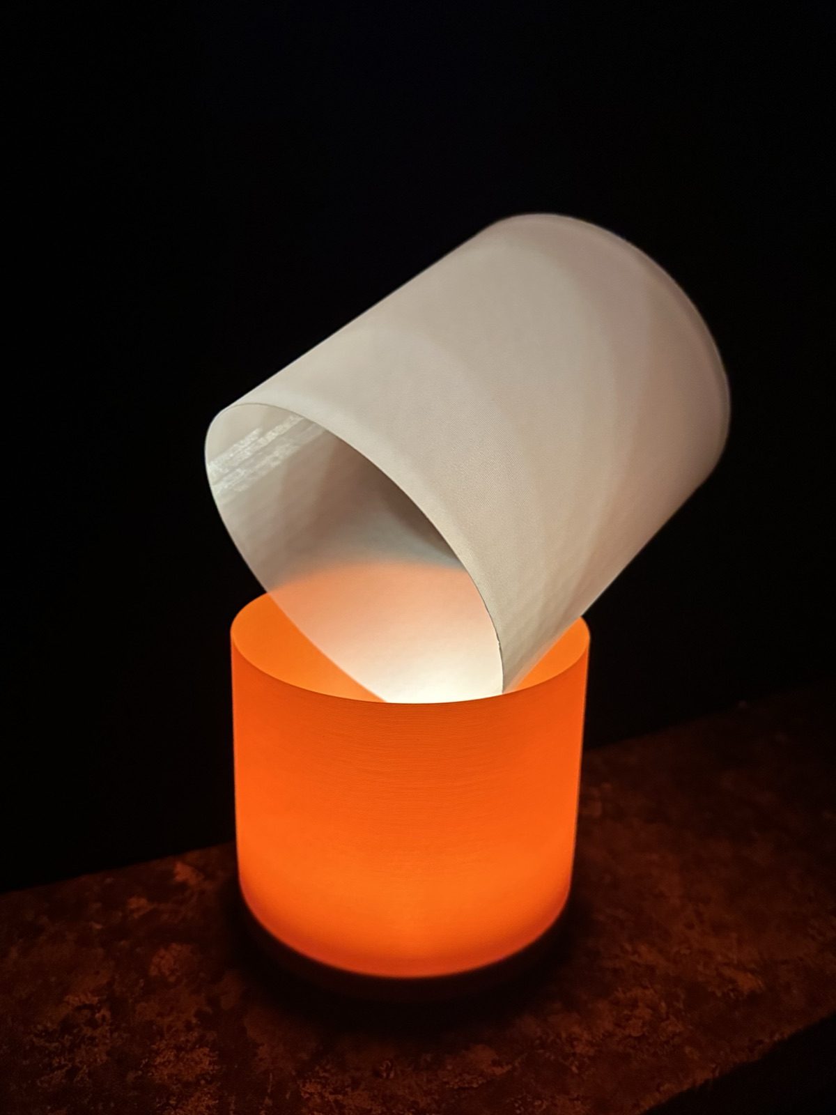 Ein weisser Schirm schräg in einer orangen Leuchte
